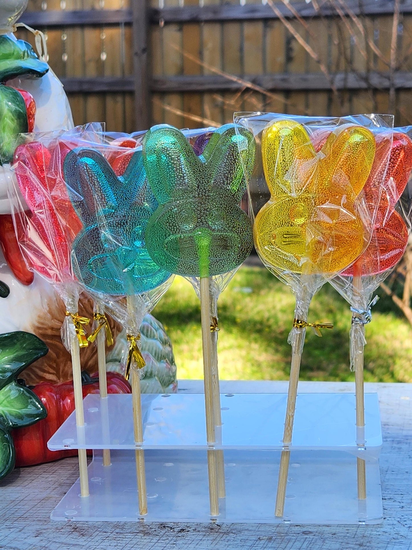 Handmade bunny lollipops on a clear acrylic stand, spring candy gift