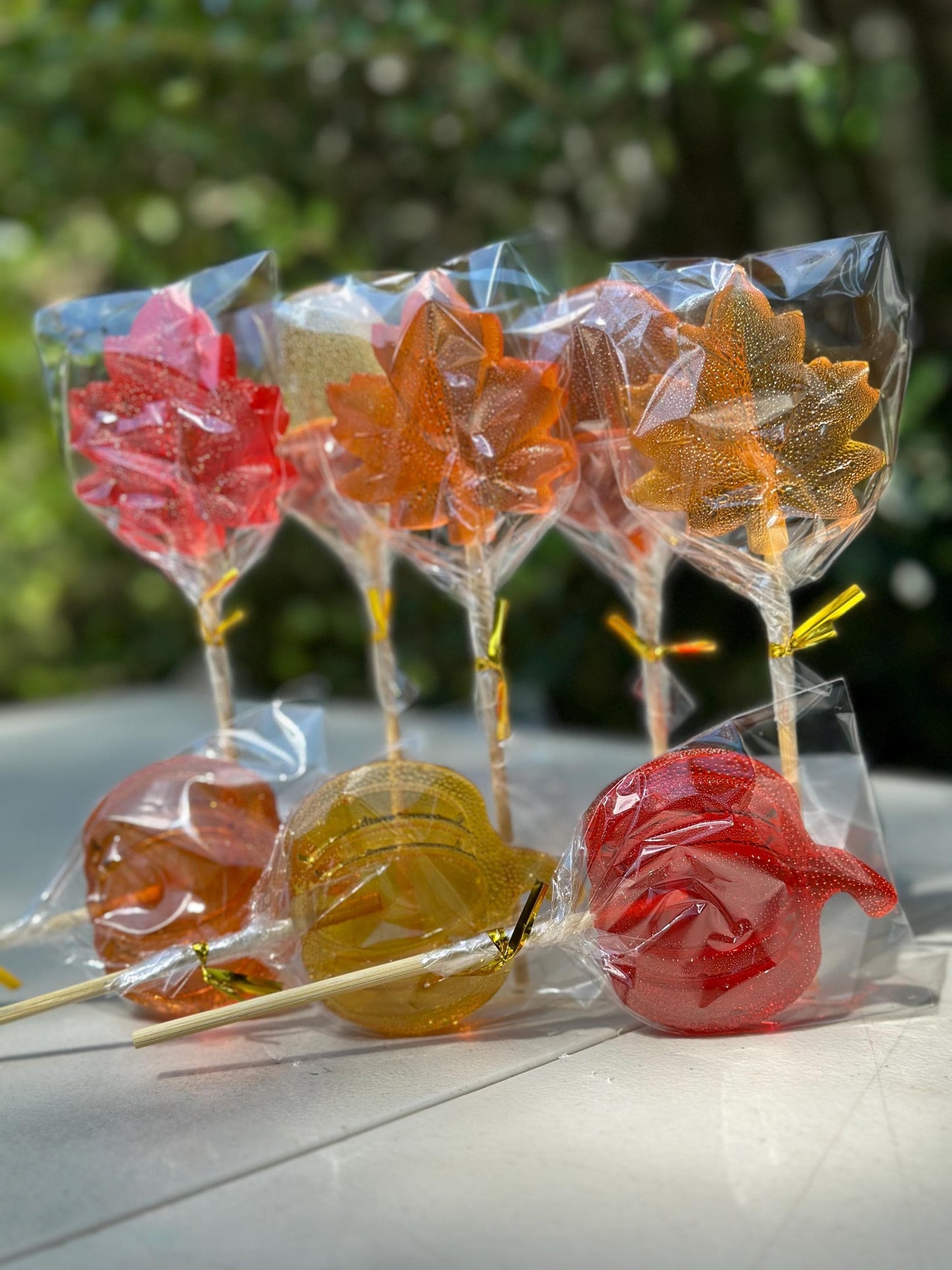 Autumn lollipops in red, orange and yellow, leaves and pumpkins