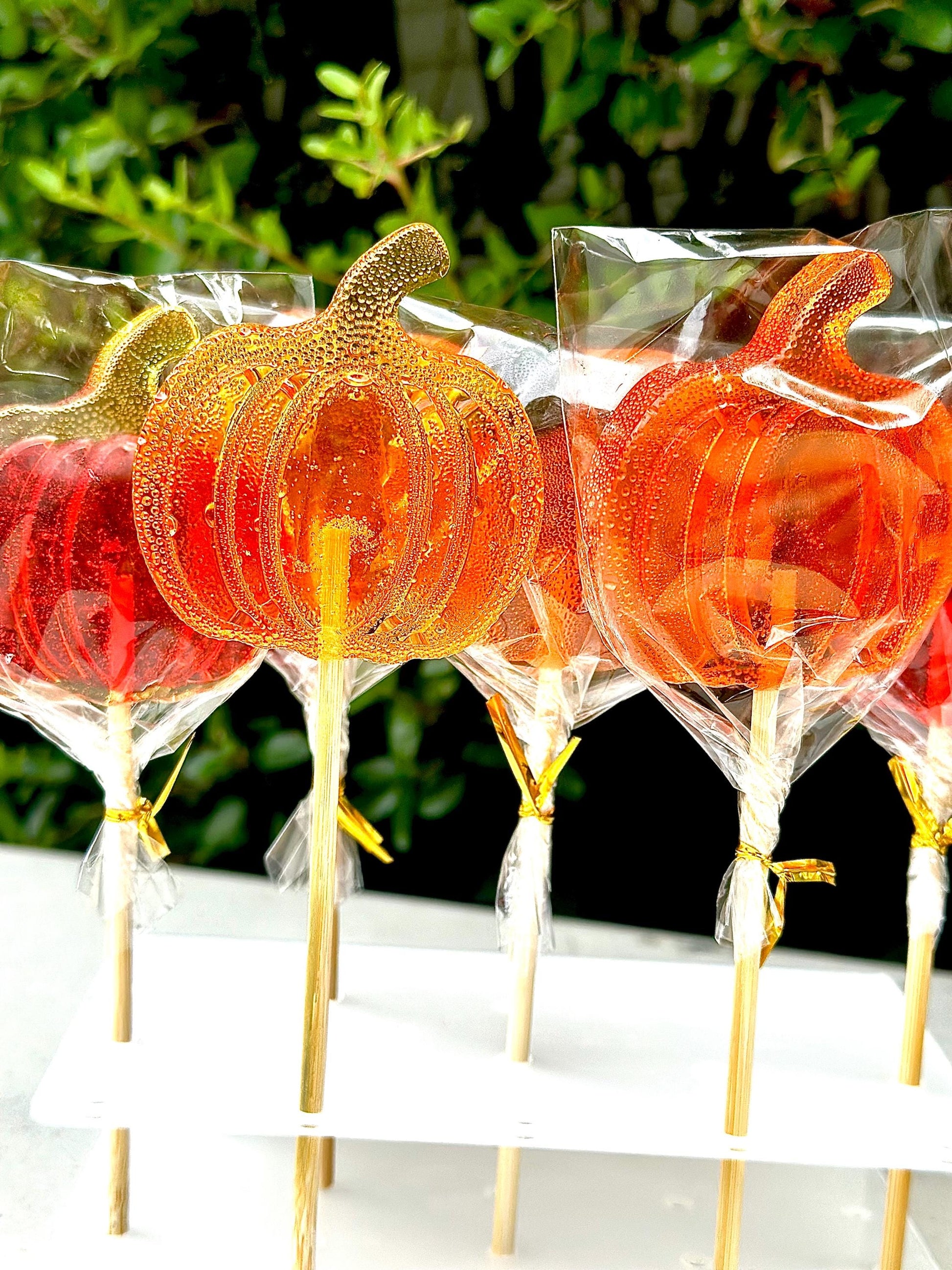 Handmade pumpkin lollipops in translucent orange candy, Halloween party favors