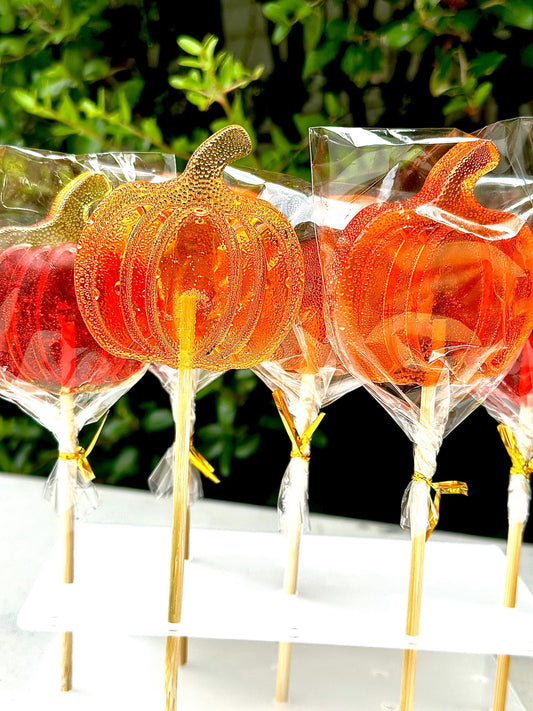 Handmade pumpkin lollipops in translucent orange candy, Halloween party favors