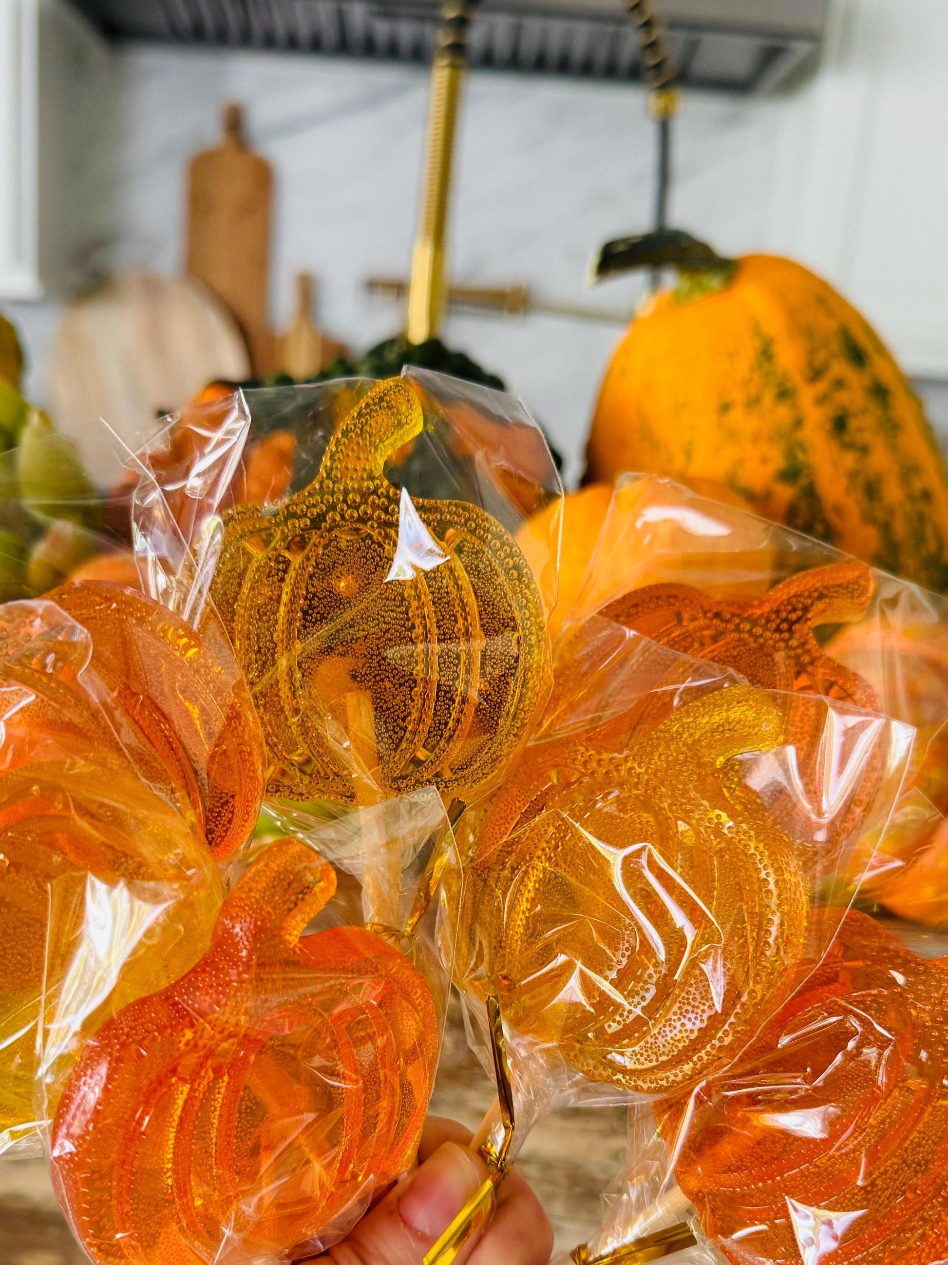 Bouquet of orange pumpkin lollipops wrapped in clear cellophane