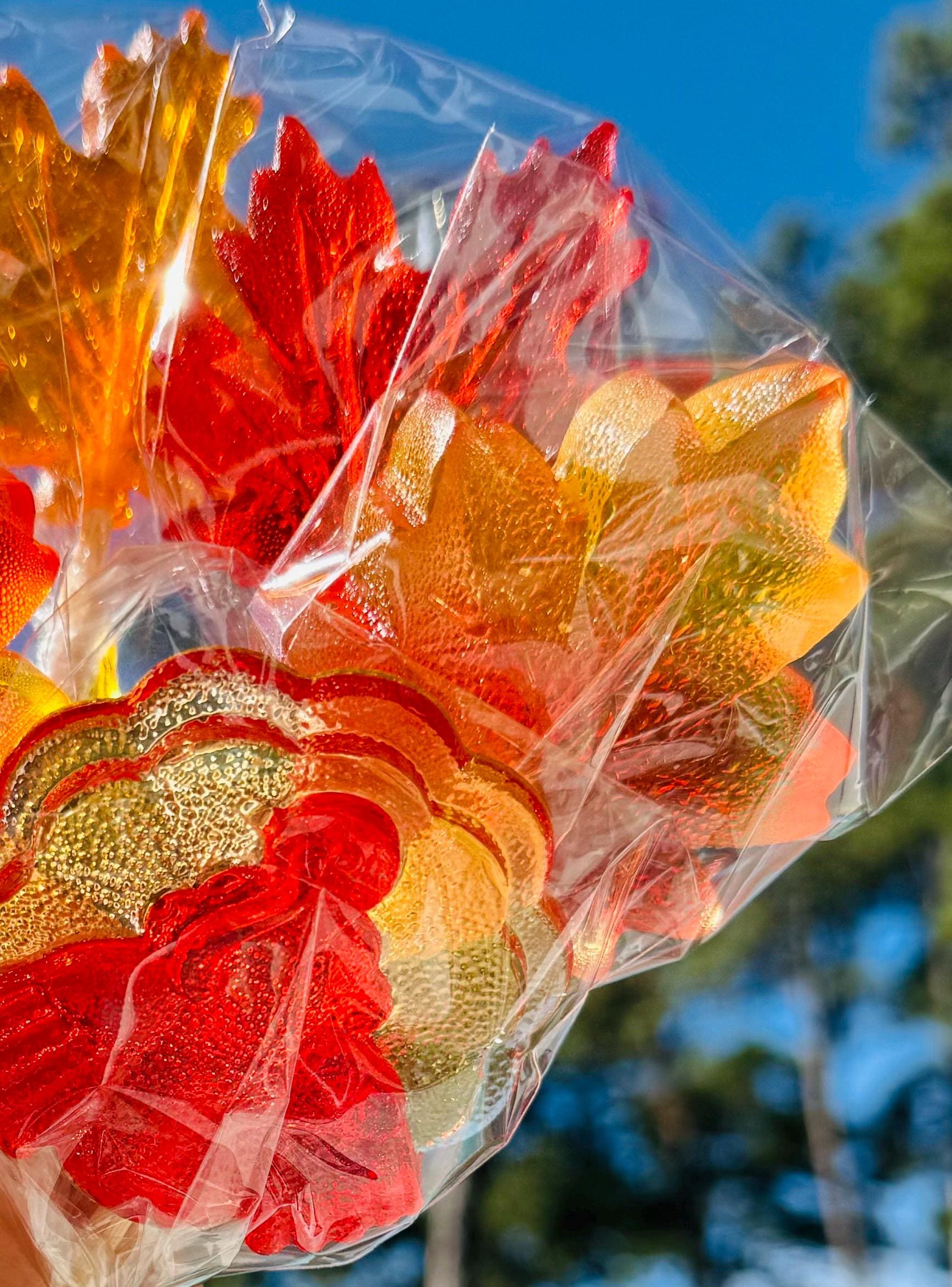Bouquet of candy autumn leaves in red, orange and yellow with a glossy finish