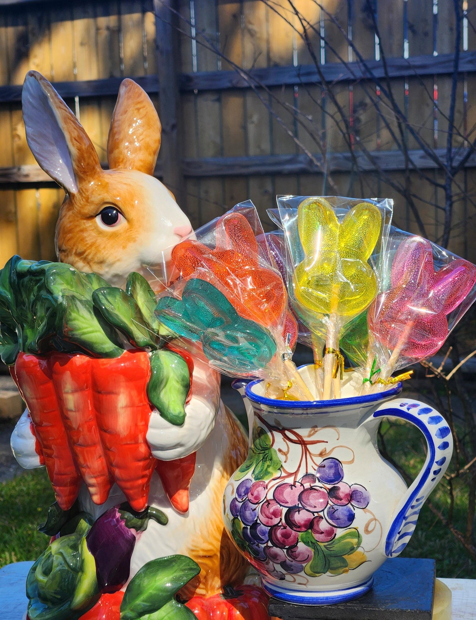 Bouquet of Easter bunny lollipops beside a ceramic rabbit figurine