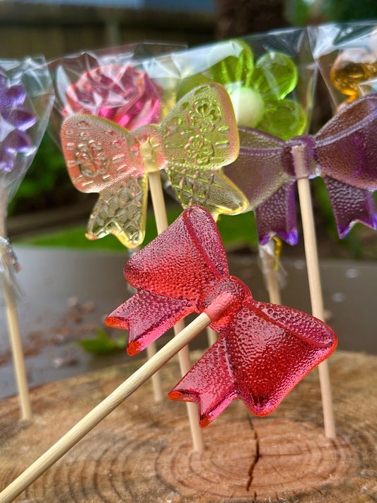 Handmade bow lollipops in bright custom colors, individually wrapped candy party favors